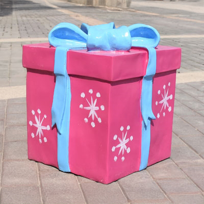 Pink fiberglass Gift Box Sculpture with blue ribbon and snowflake designs