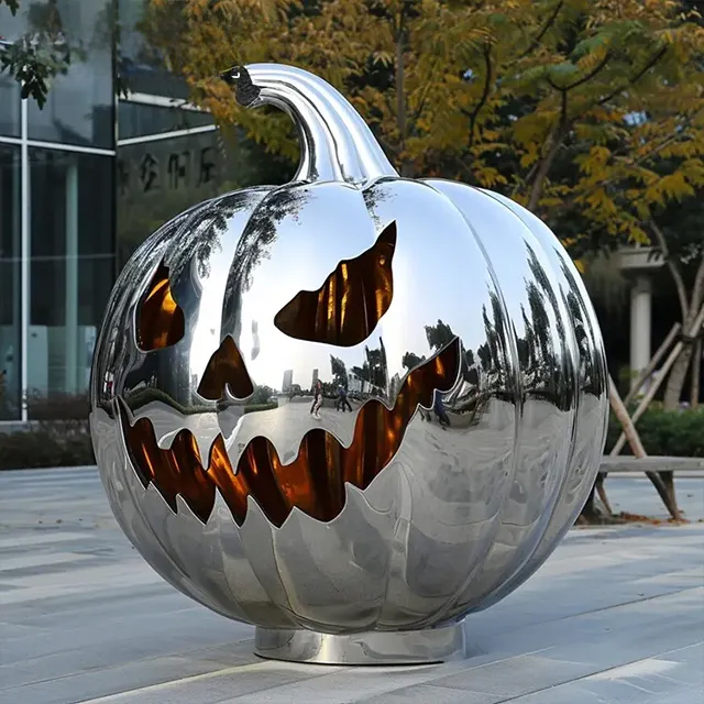 Shiny stainless steel Metal Pumpkin Sculpture with carved Halloween face design