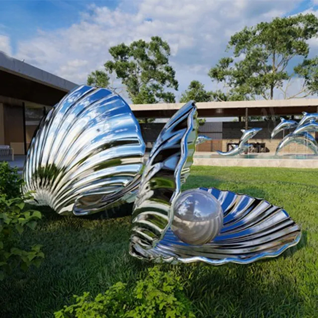 Shiny stainless steel Shell Statue displayed on green grass