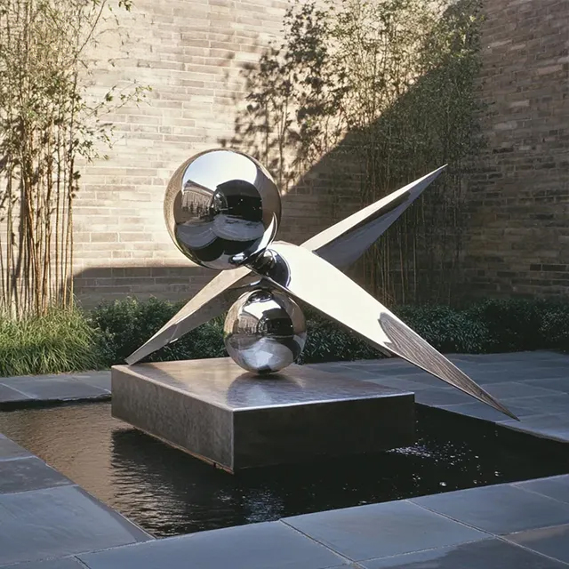 Stainless steel Metal Ball Garden Sculpture featuring two spheres connected by wing-shaped geometric elements