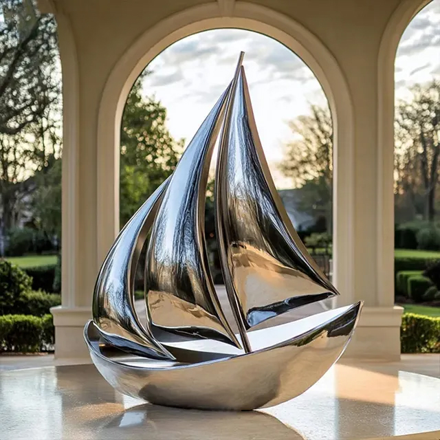 Stainless steel Silver Sailboat Sculpture featuring sleek reflective sails