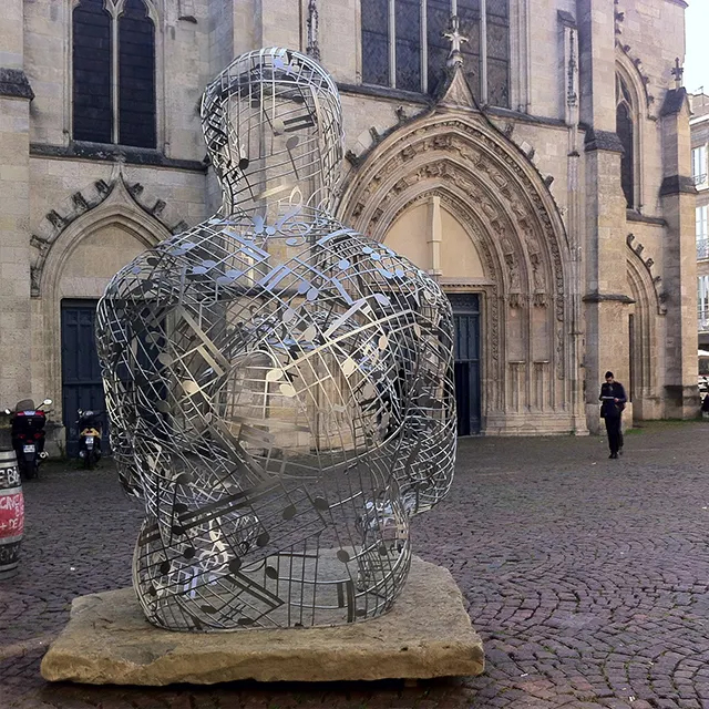 Stainless steel Wire Human Figure sculpture placed on a stone base