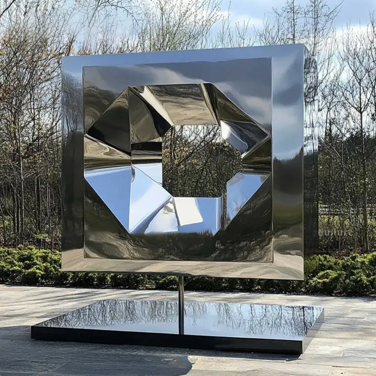 Stainless steel abstract cube sculpture with faceted geometric hollow
