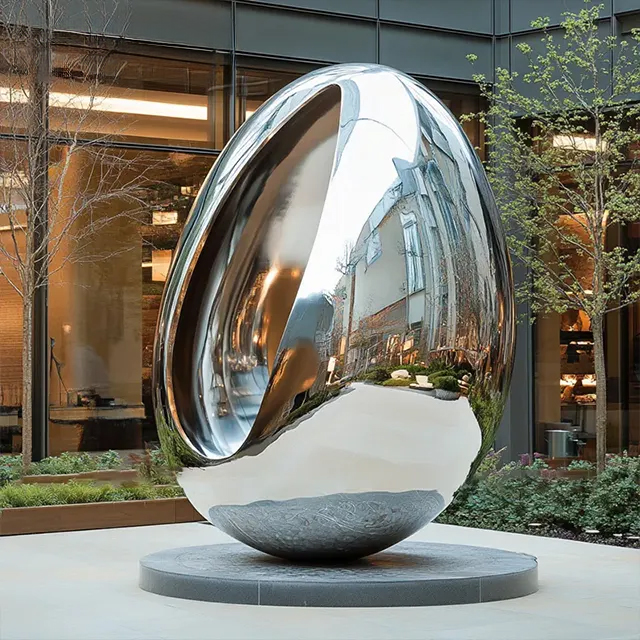 Stainless steel egg shaped sculpture featuring smooth reflective finish