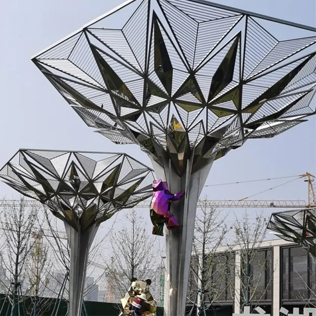 Stainless steel geometric tree sculpture with reflective canopy and colorful climbing bear figures