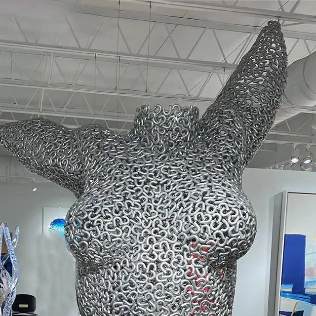 Stainless steel torso sculpture of a female figure