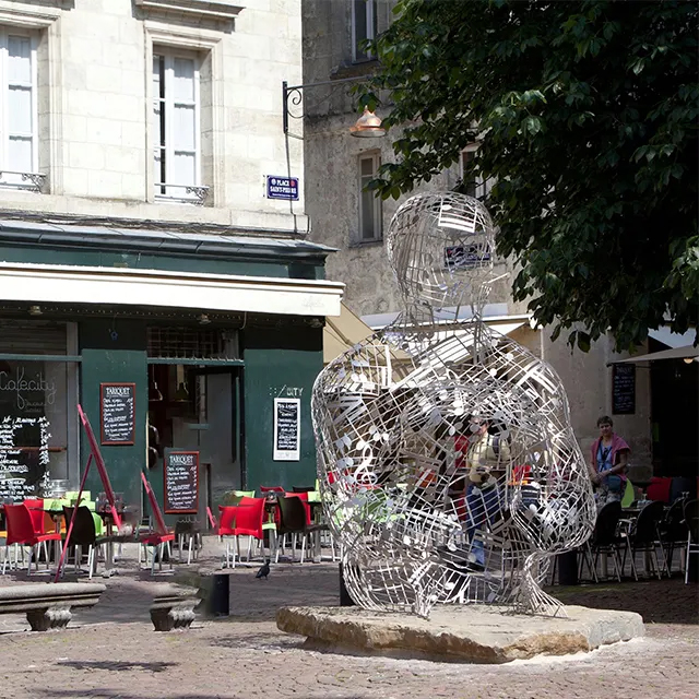 Wire Human Figure made of stainless steel seated quietly