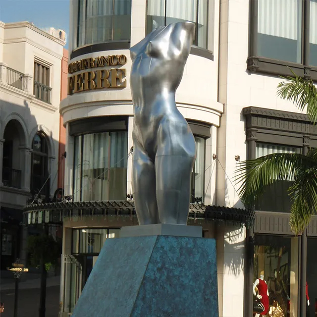 Woman Torso Statue in stainless steel standing on marble pedestal