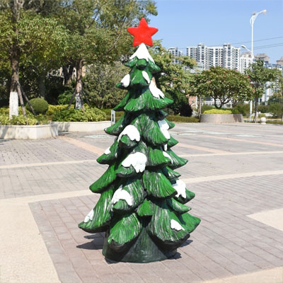 fiberglass Sculpture Christmas Tree with red star topper and snow-covered branches