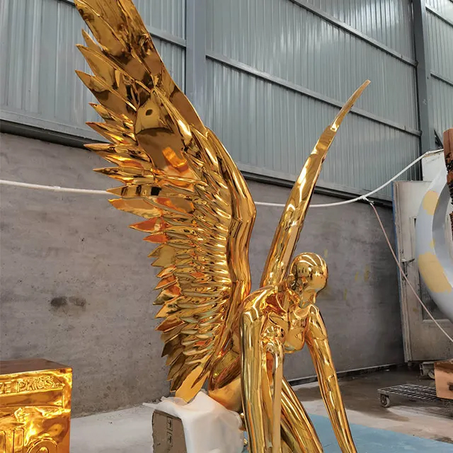 gold angel sculpture made of stainless steel with extended wings