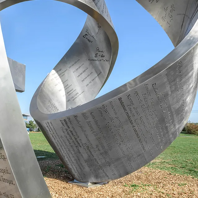 large stainless steel Knowledge Sculpture with engraved scientific formulas and equations