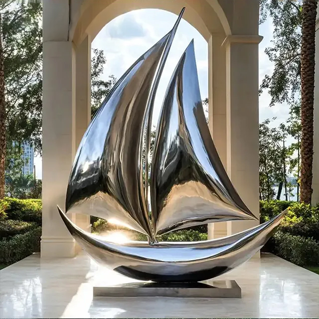 polished Silver Sailboat Sculpture in stainless steel with curved abstract sails
