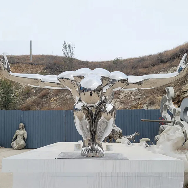 stainless steel Diver Sculpture in crouching pose with arms extended outward