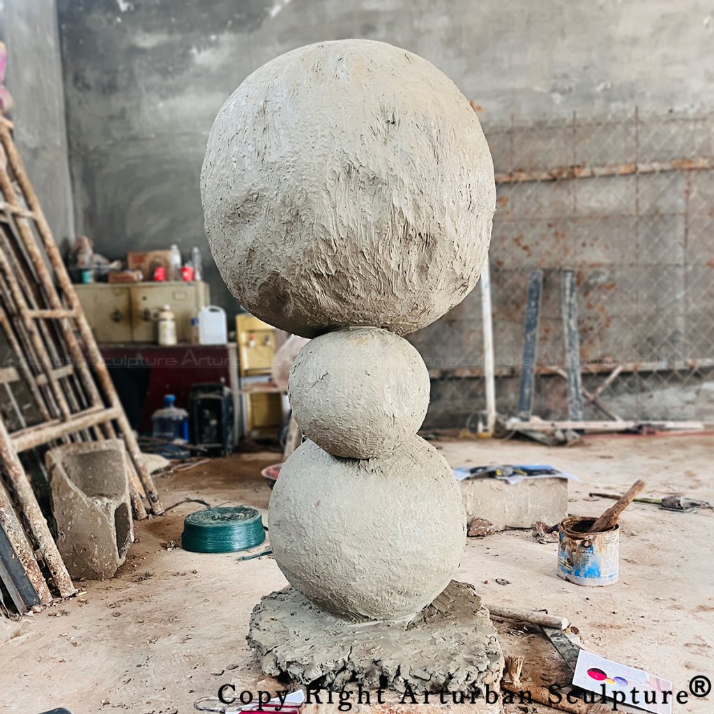 2-Clay model of Annie Morris stack Sculpture showing three rough-textured spheres