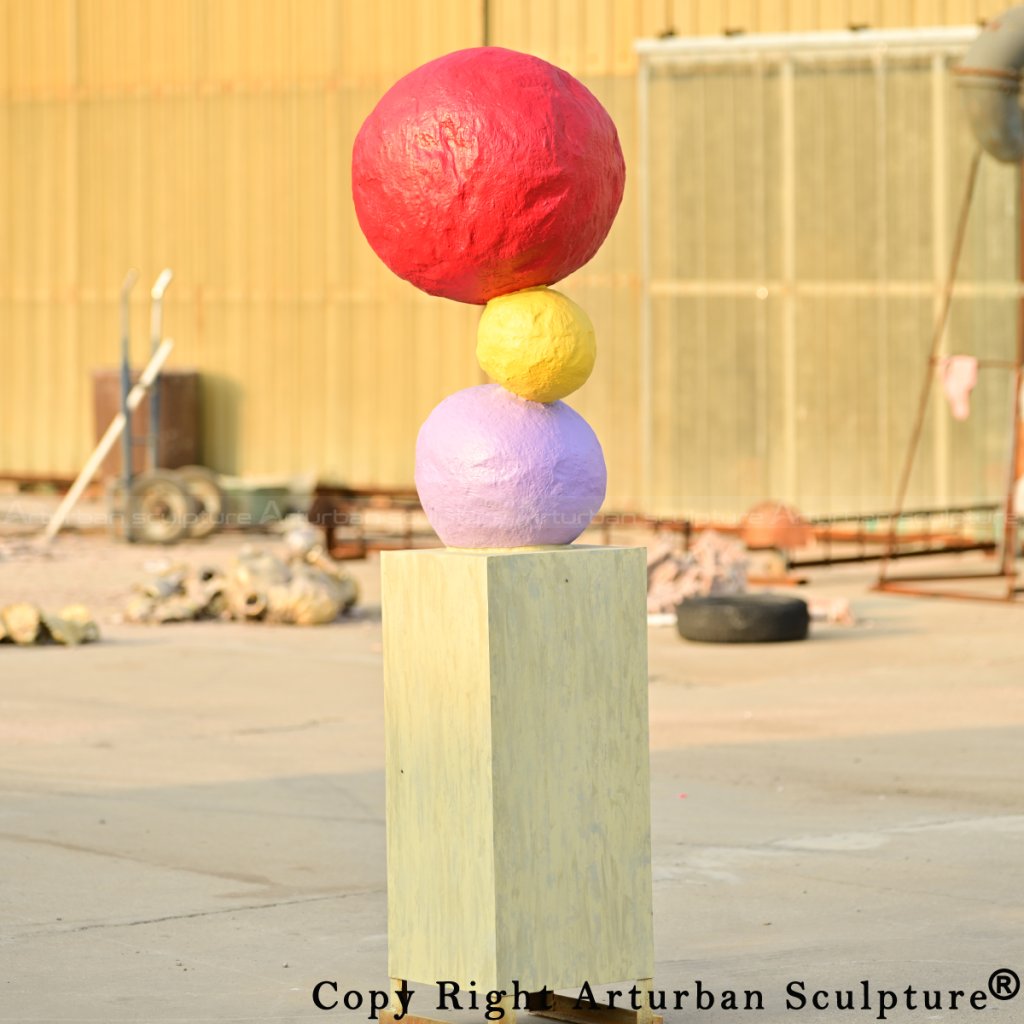 4-Bronze Annie Morris Sculpture with bright red, yellow, and purple spheres arranged vertically