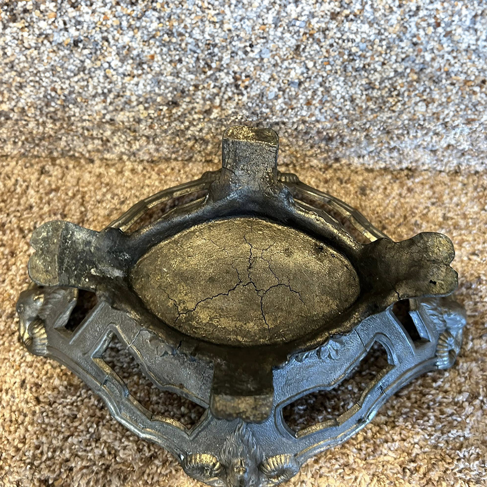 Bottom view of antique bronze Metal Jardiniere Planter showing aged surface
