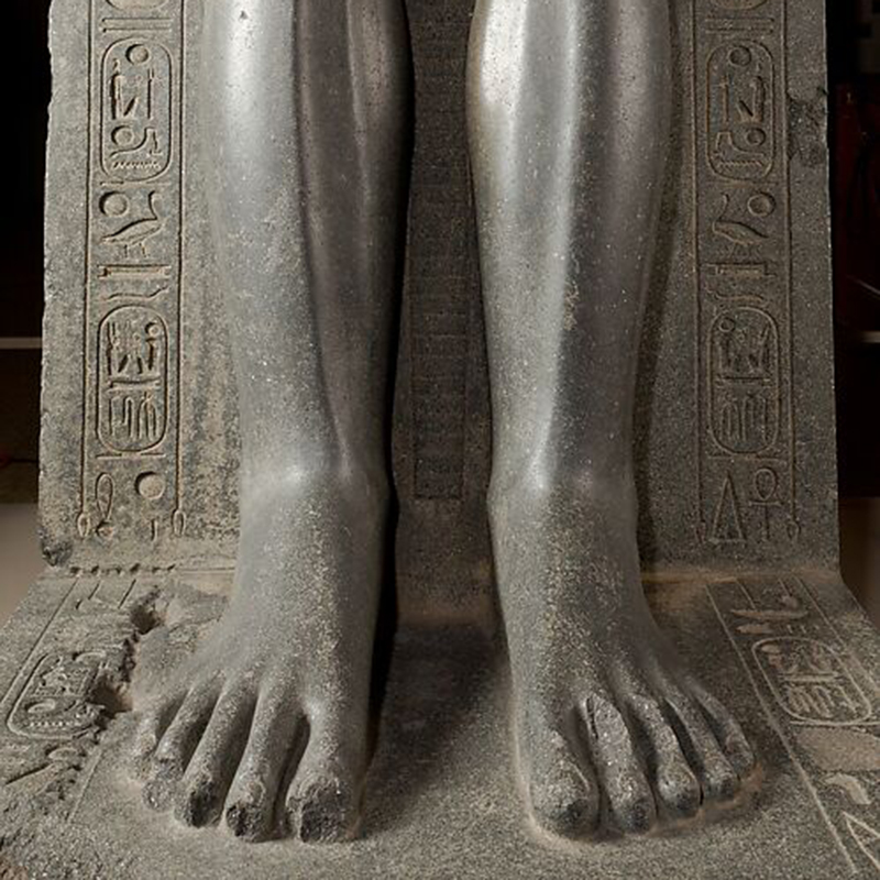 Close-up-view-of-legs-and-hieroglyphs-on-Seated-Pharaoh-Statue