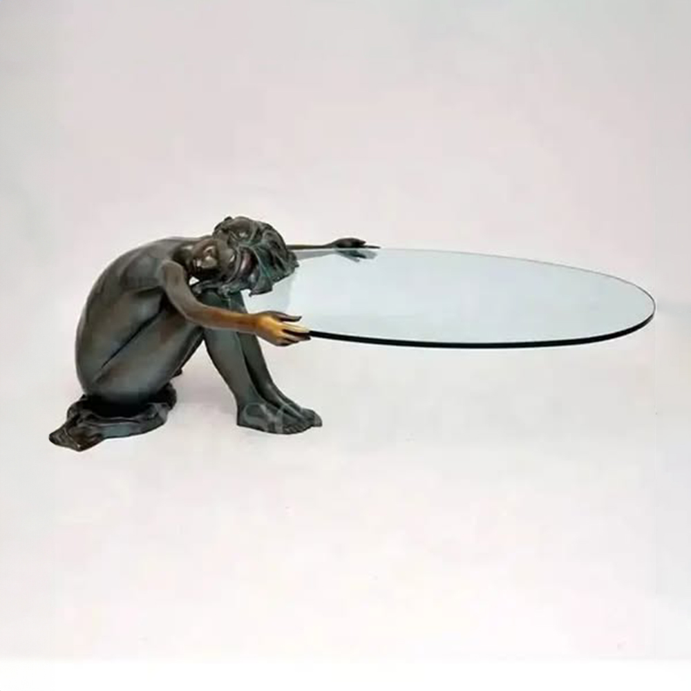 Side view of Woman Statue Coffee Table with bronze female figure supporting oval glass top