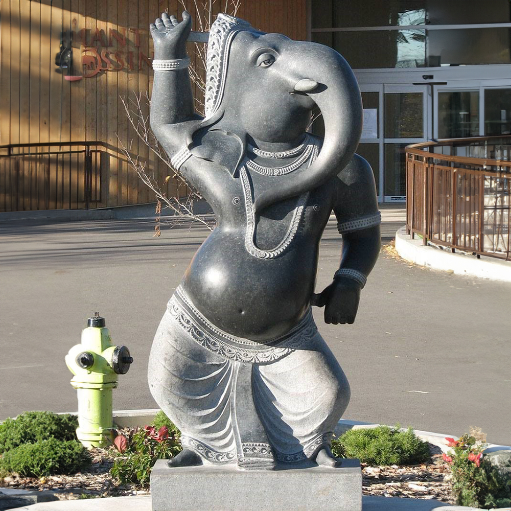 Stone Ganesh Statue in Stone with dancing pose and detailed carvings.