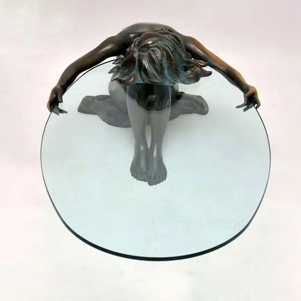 Top view of Woman Statue Coffee Table featuring bronze woman sculpture holding glass tabletop