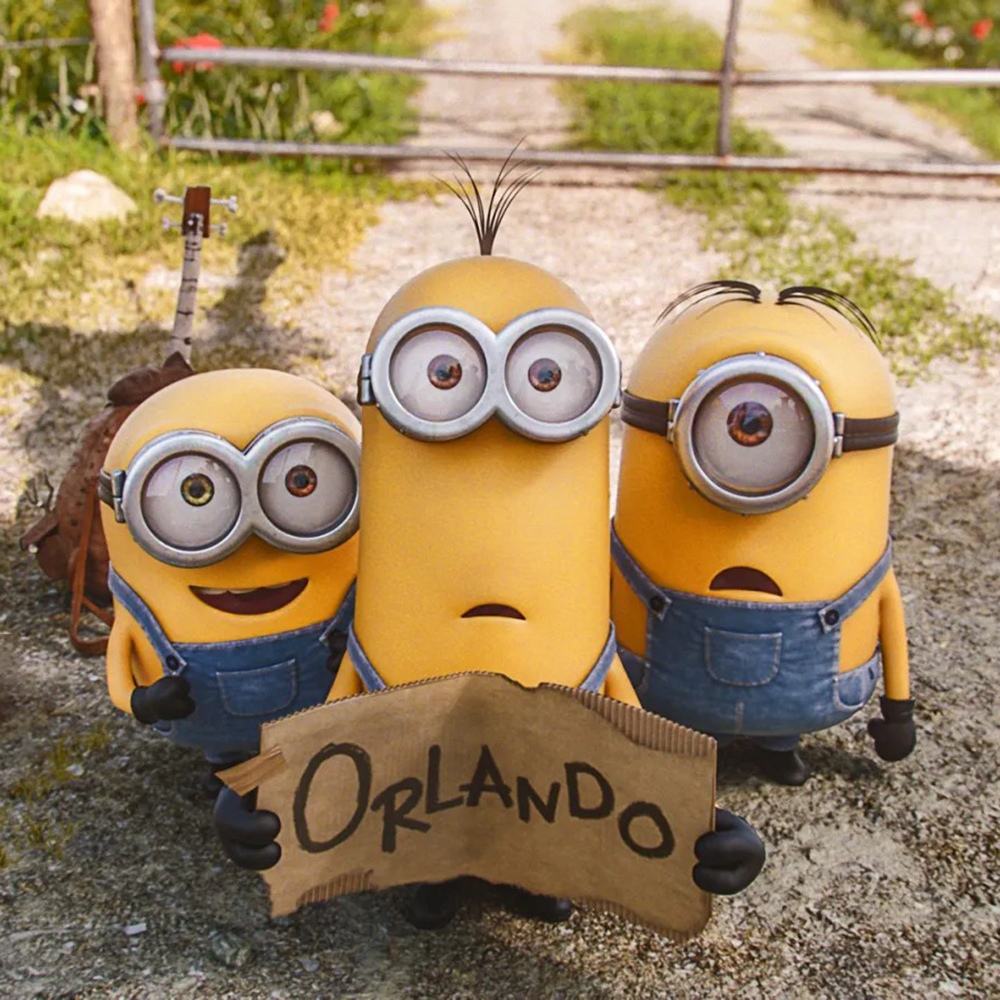 1-Three Minions holding a cardboard sign