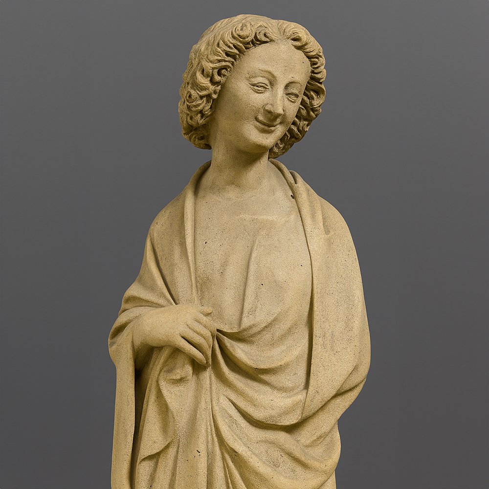 French Gothic stone sculpture face with a gentle smile