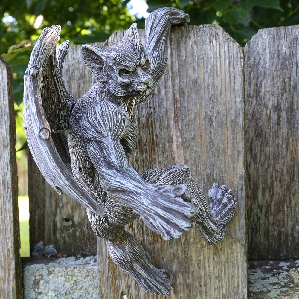 Gargoyle Fence Hanger clinging to a wooden fence