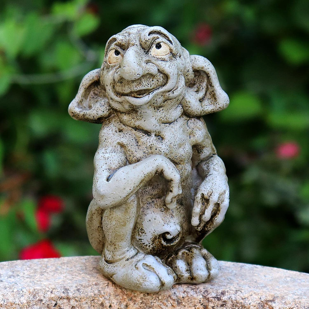 Small stone Funny Gargoyle Statue outdoors