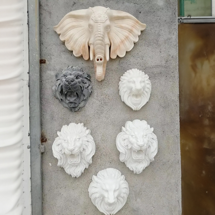 Marble lion and elephant head outdoor fountain