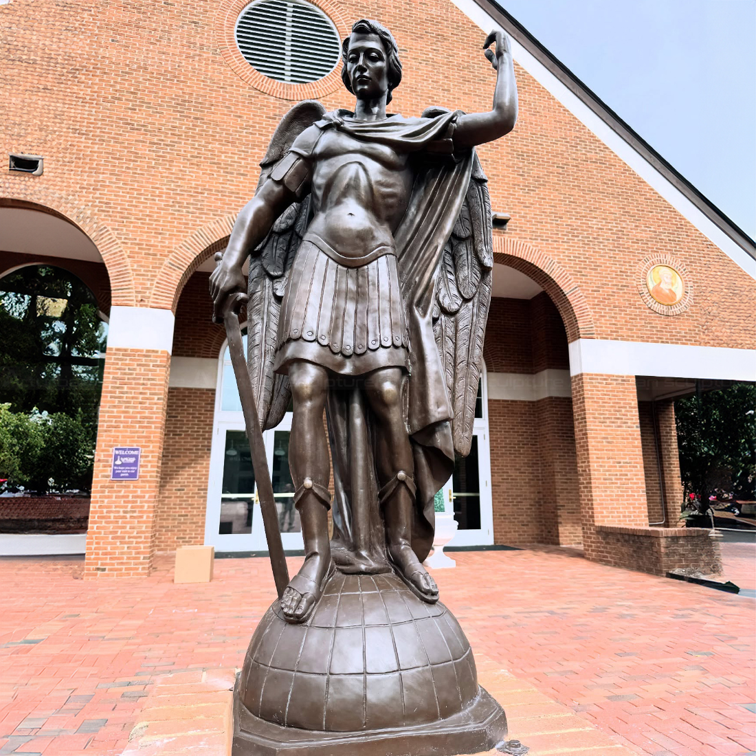 bronze Statue of Angel Michael standing on a globe