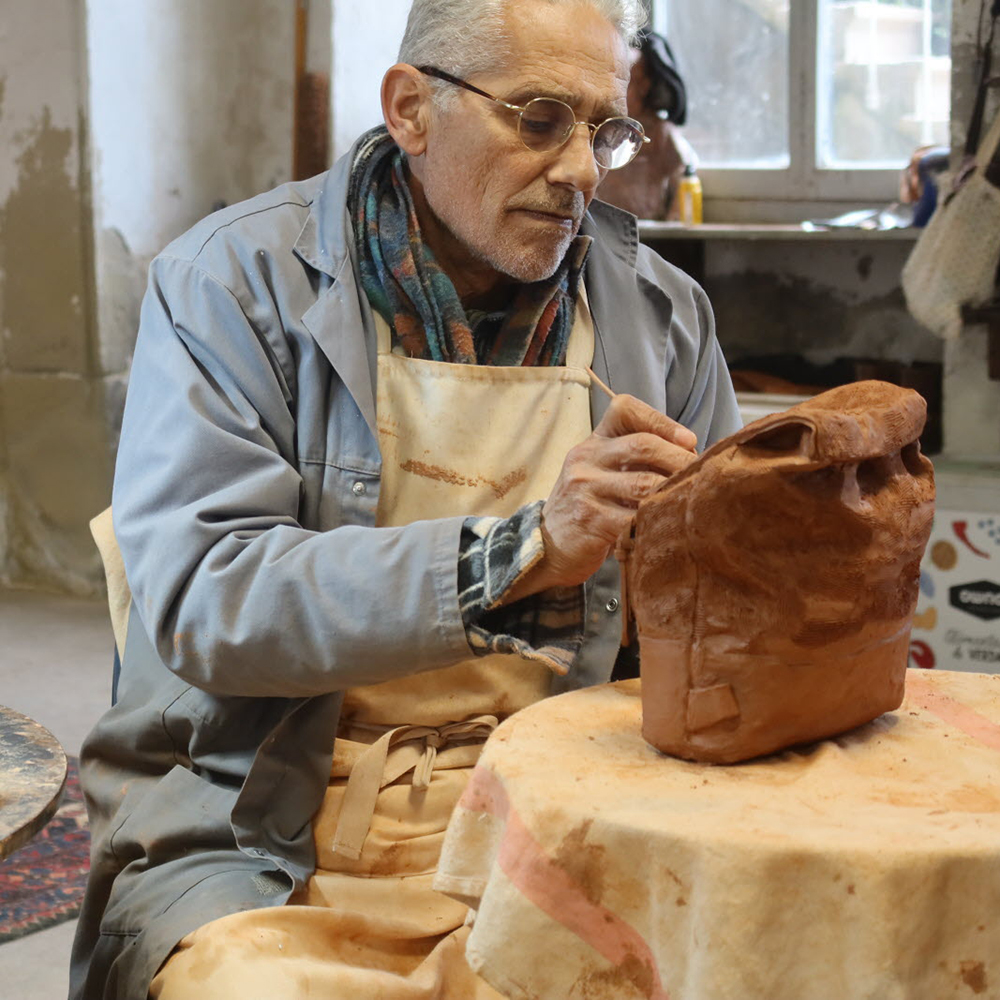 Bruno Catalano sculpting clay traveler figure