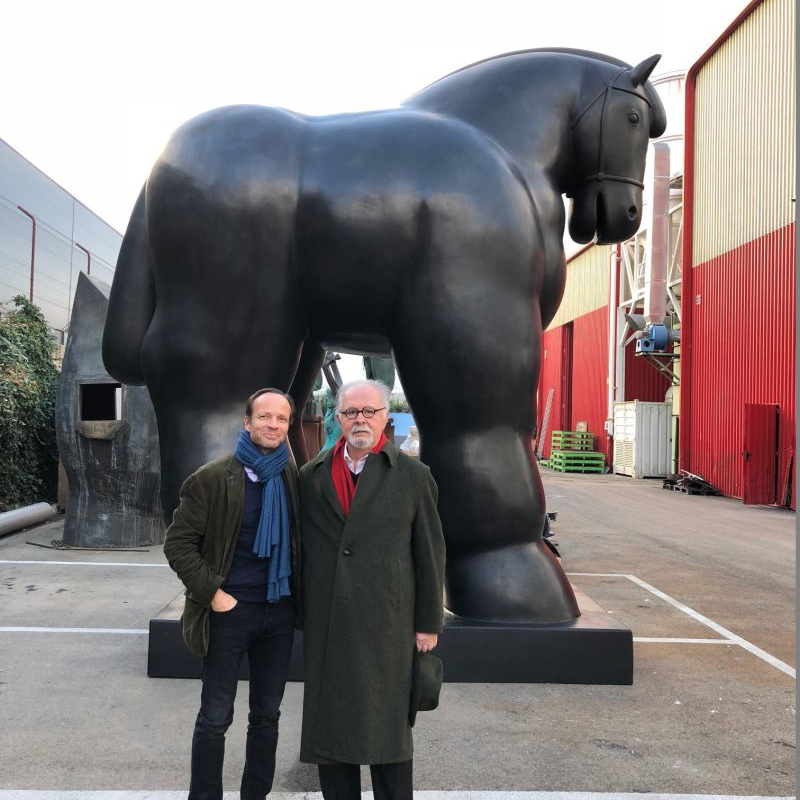 Large Botero style horse sculpture with artist