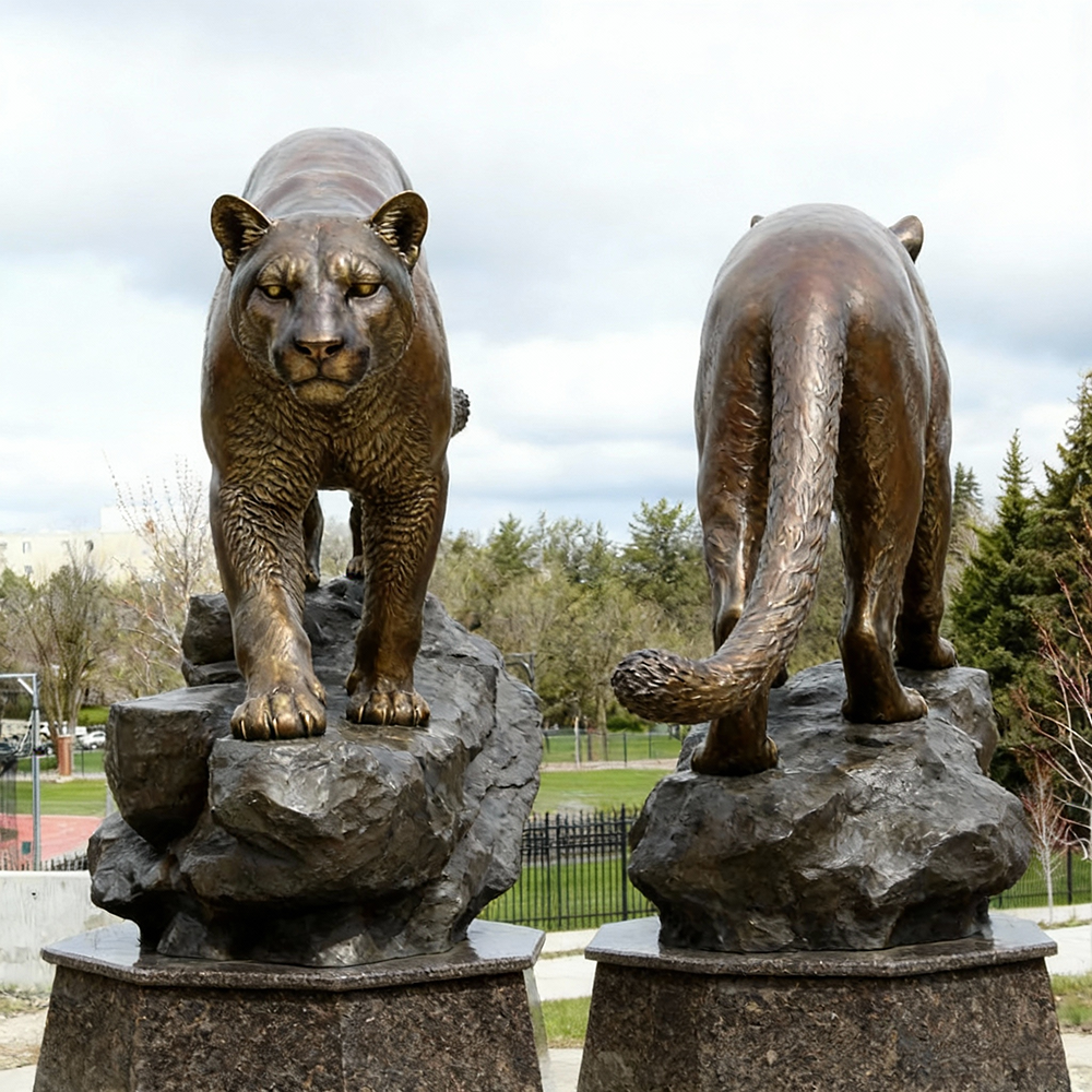 Bronze Puma Sculpture standing on rugged rock