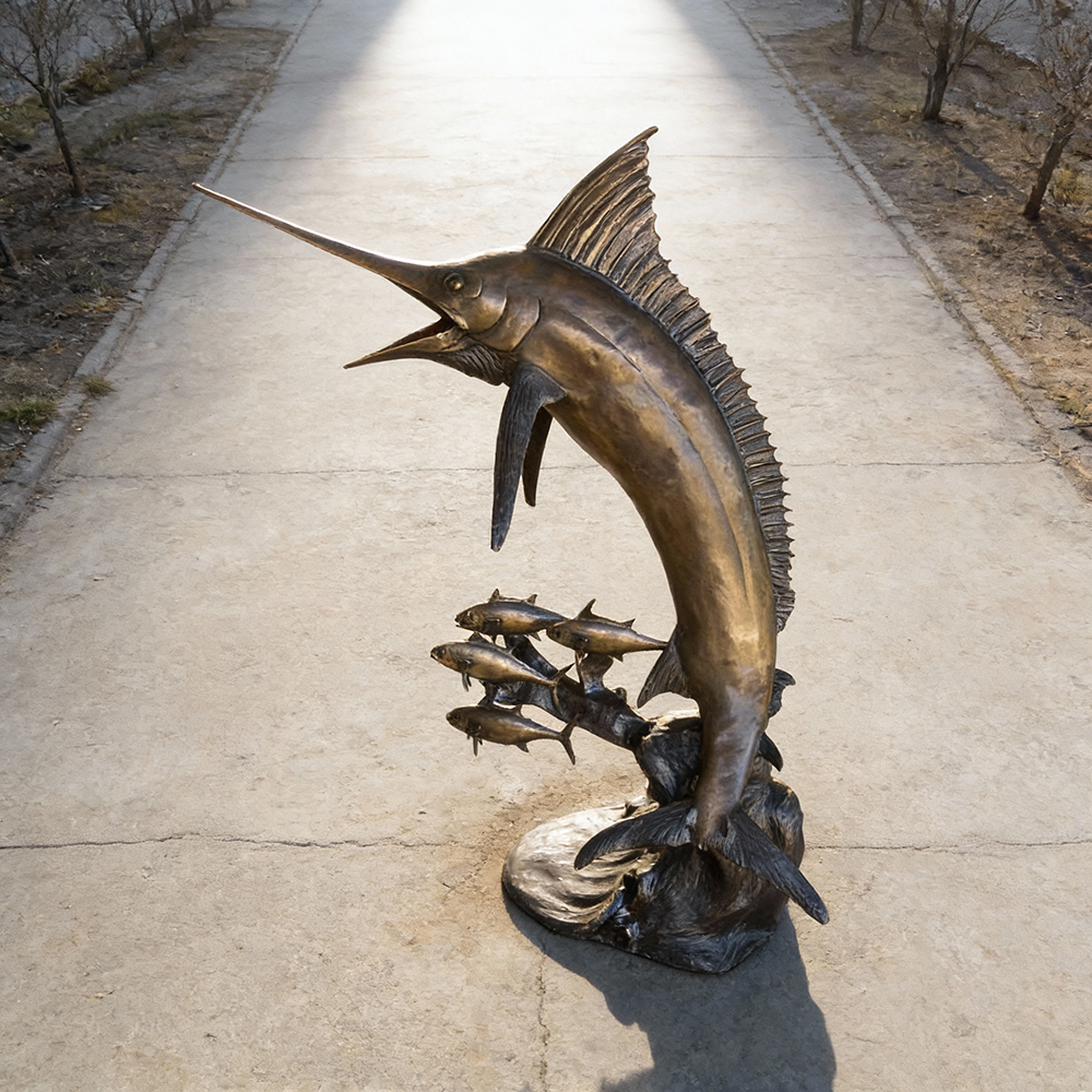 Bronze marlin fish sculpture with chasing small fish