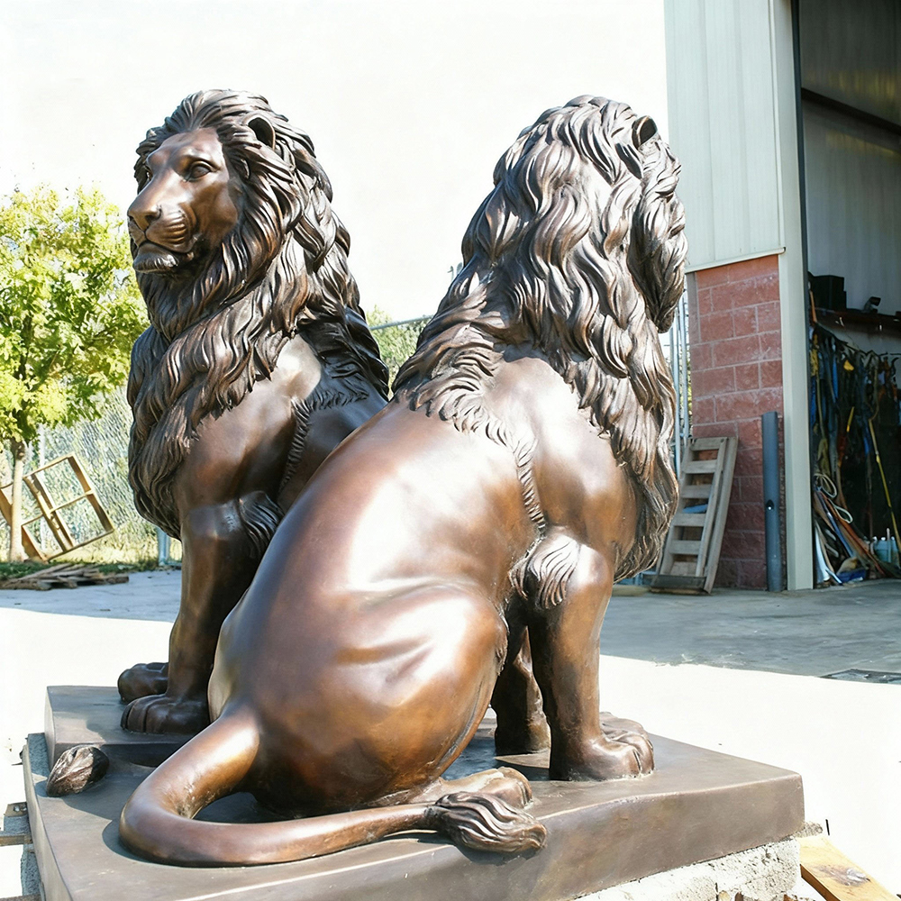 Side profile of paired bronze lion statues