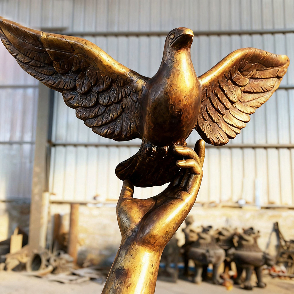 bronze Angel with Dove Statue hand holding dove detail