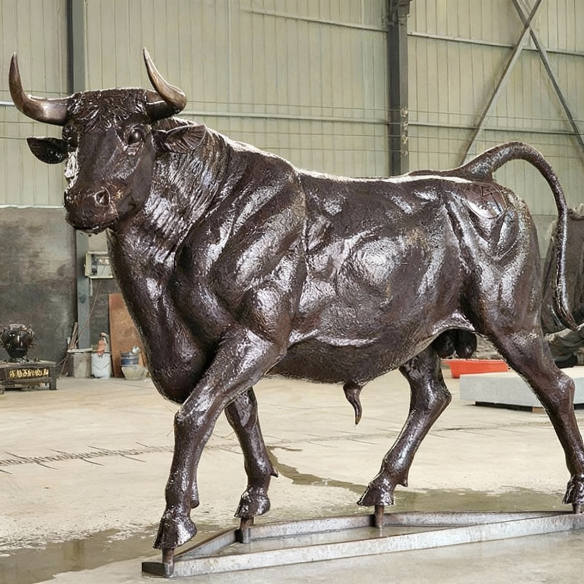 bronze Ox Sculpture in workshop standing on metal base
