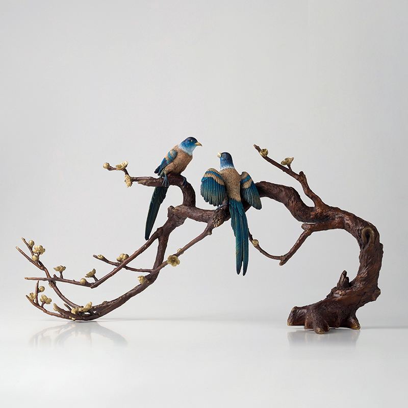 bronze magpie sculpture pair on flowering branch