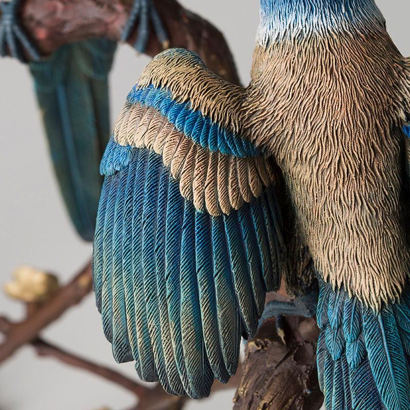 close-up bronze magpie sculpture wing feather detail