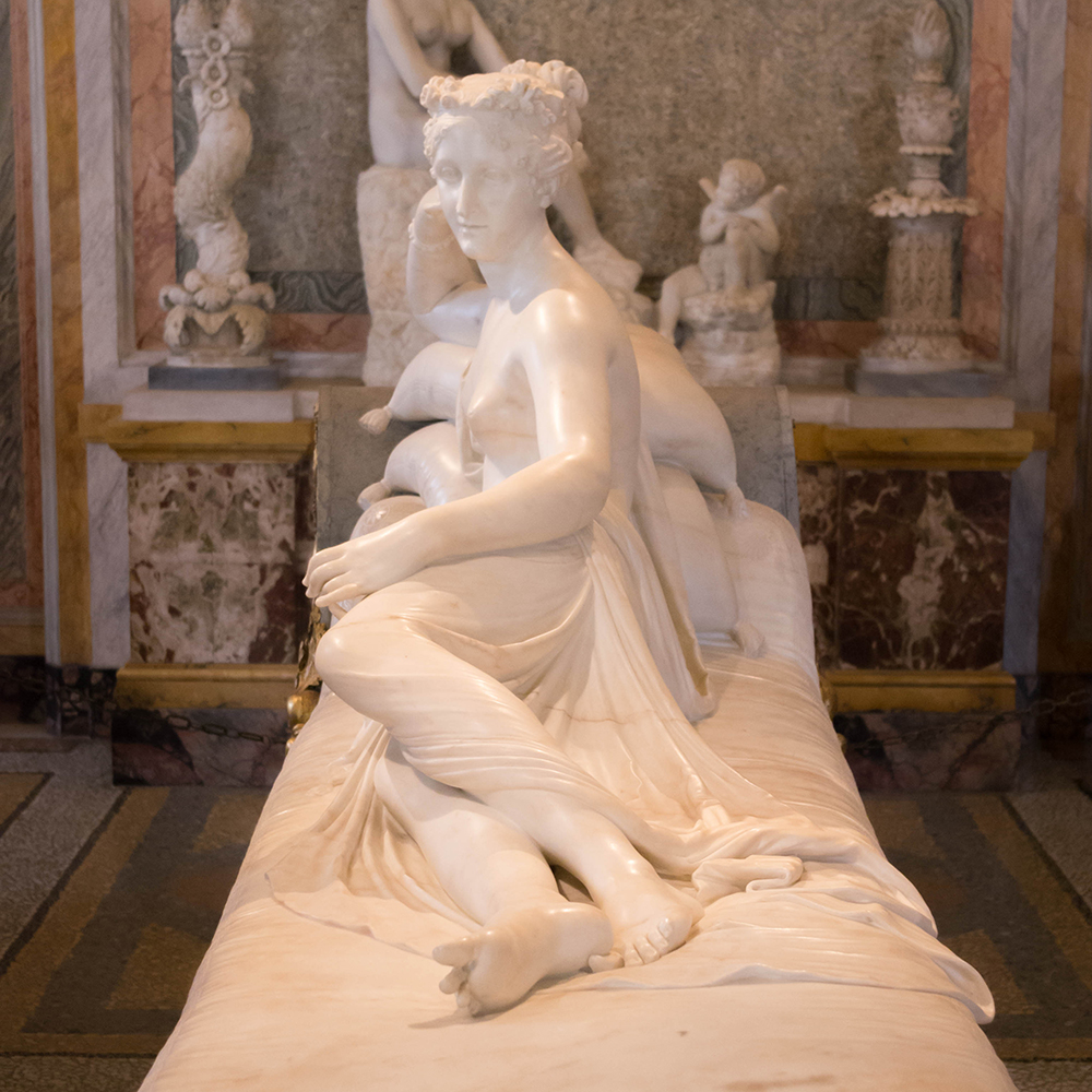 Marble Venus reclining in ornate gallery setting