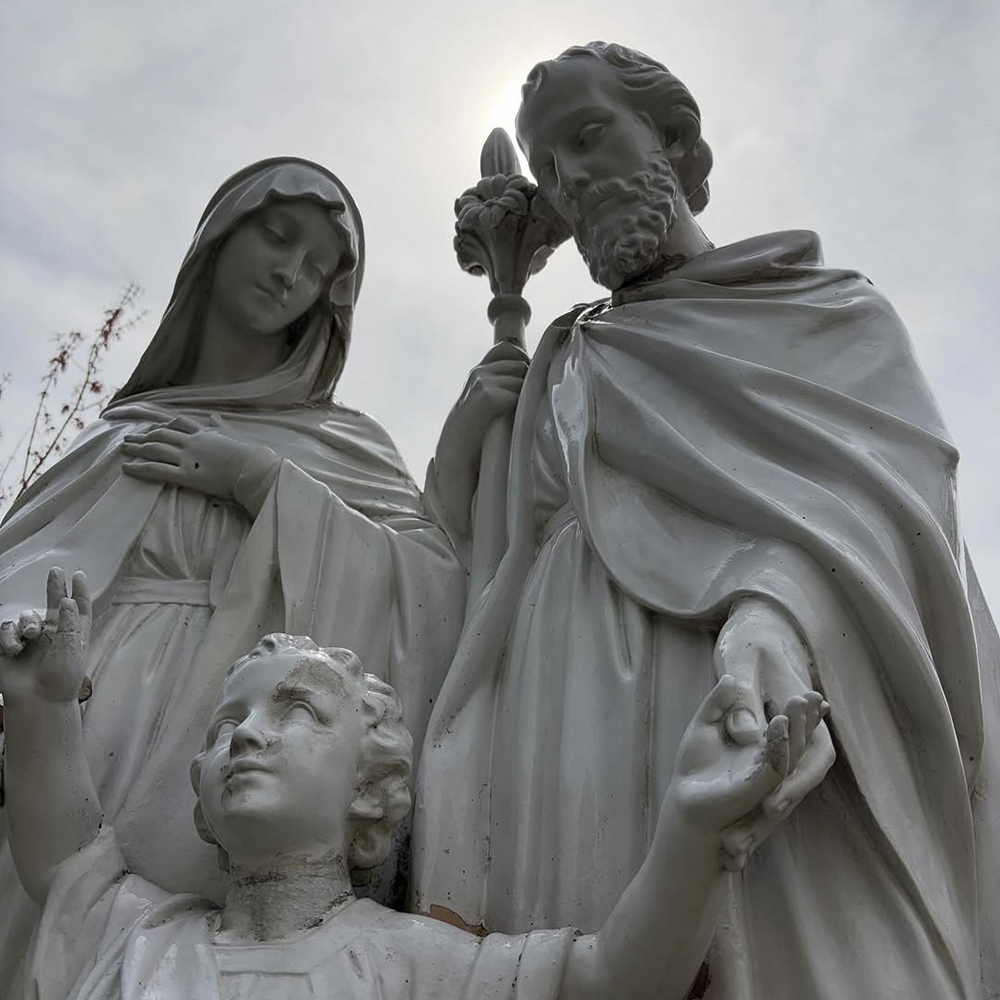 1-(3) stone Holy Family statue outdoor in the parish courtyard