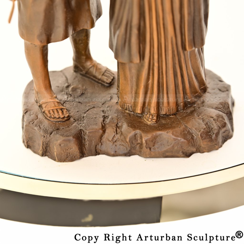 4-Close-up of feet on the statue base, showing textured rocky ground