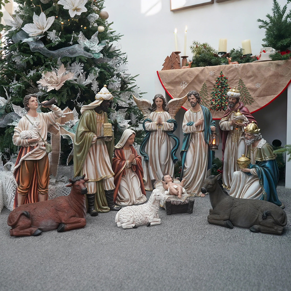 Fiberglass nativity set beside Christmas tree