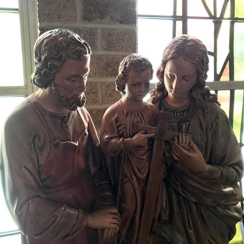 Indoor holy family statue holding cross