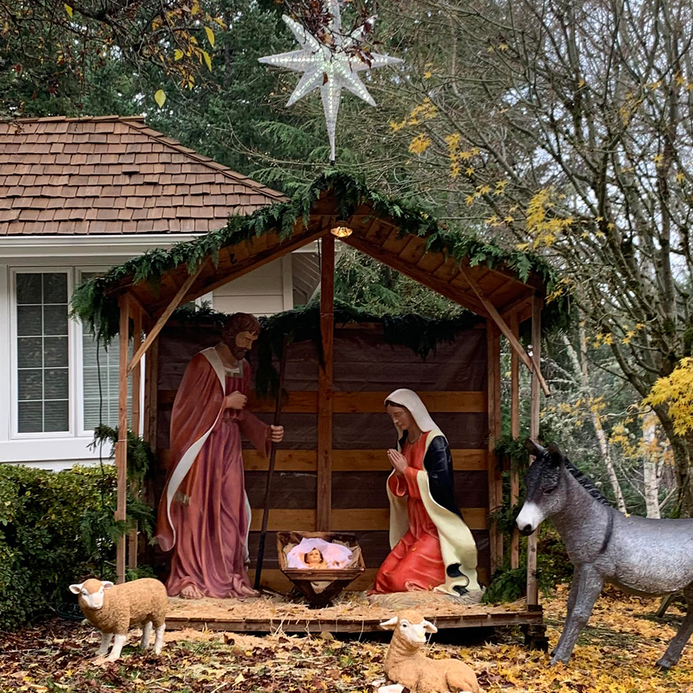 Wooden shelter holy family statue outdoor display