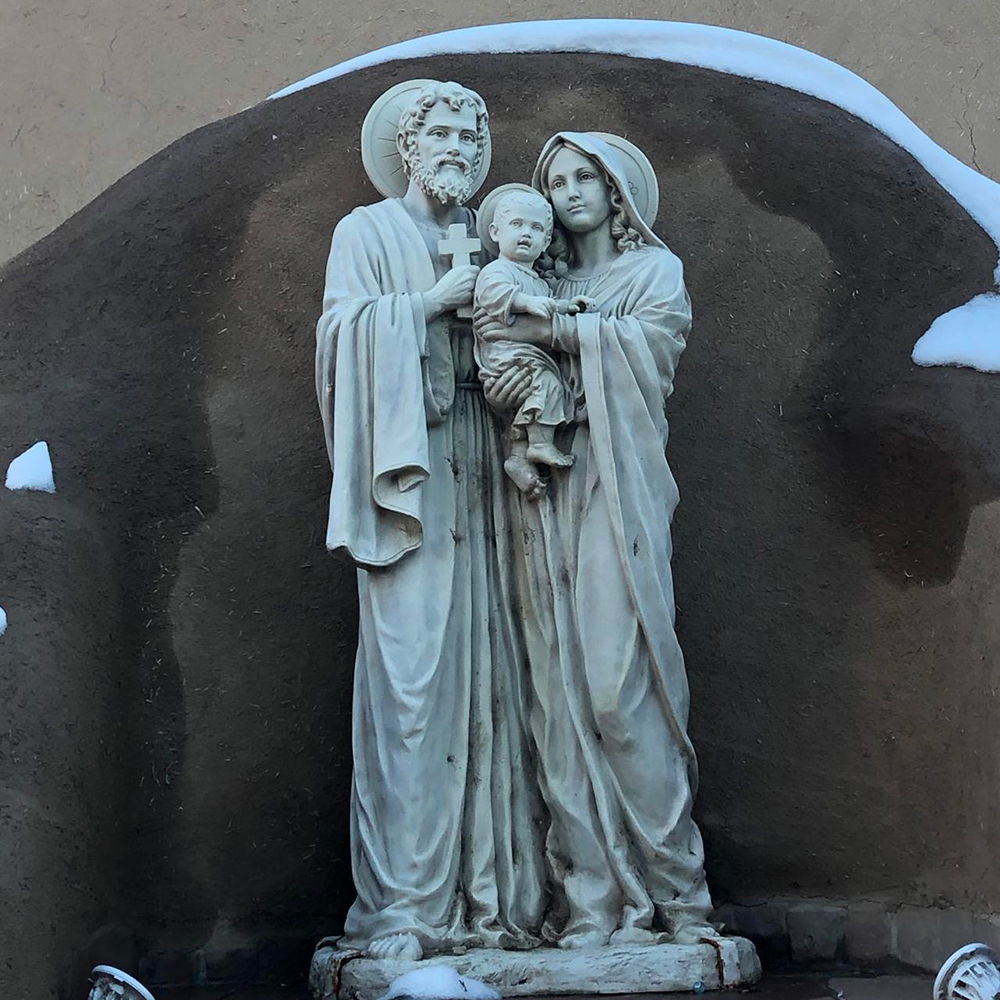statue of the Holy Family stands outside San Francis de Asis