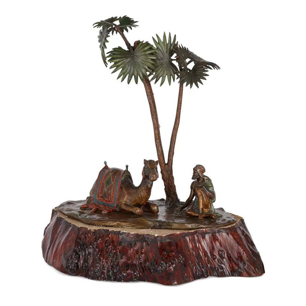 Bronze Arab and Camel Sculpture under palms