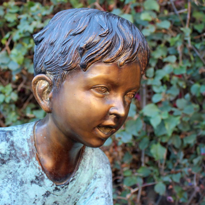 bronze Boy Fishing on Log Statue close face