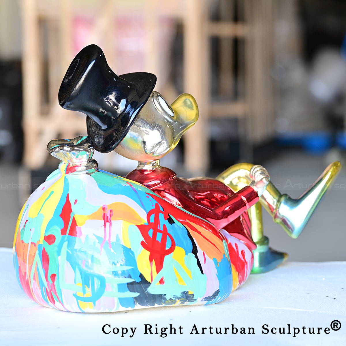 Uncle Scrooge Statue seated cartoon bronze sculpture