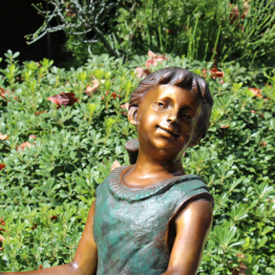 Bronze Girl Riding Tricycle Sculpture face detail